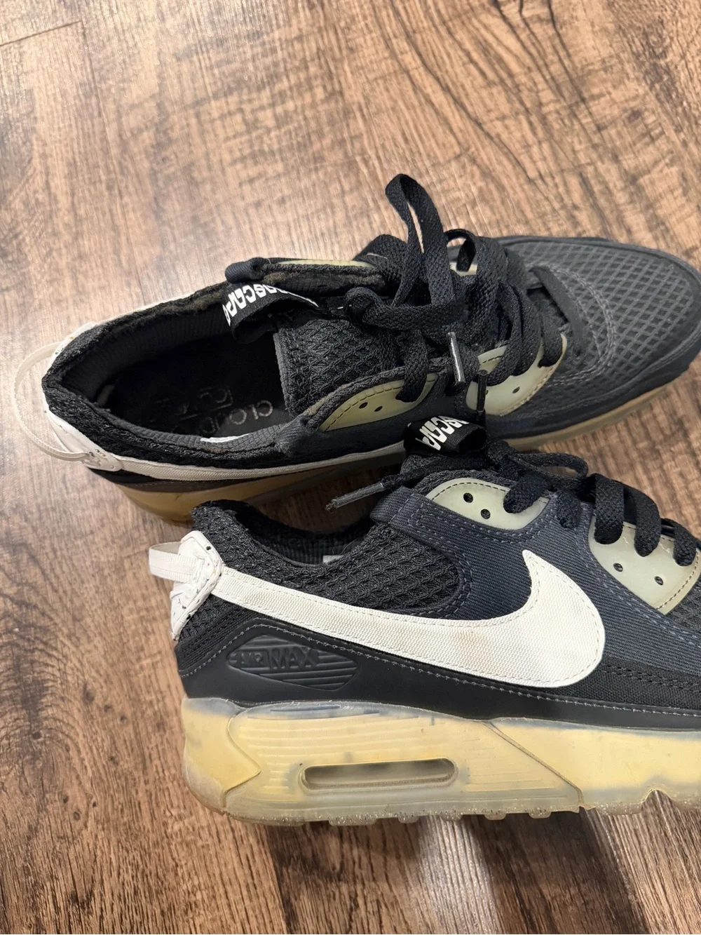 Nike Black Sneaker with White Swoosh and Yellowed Midsole